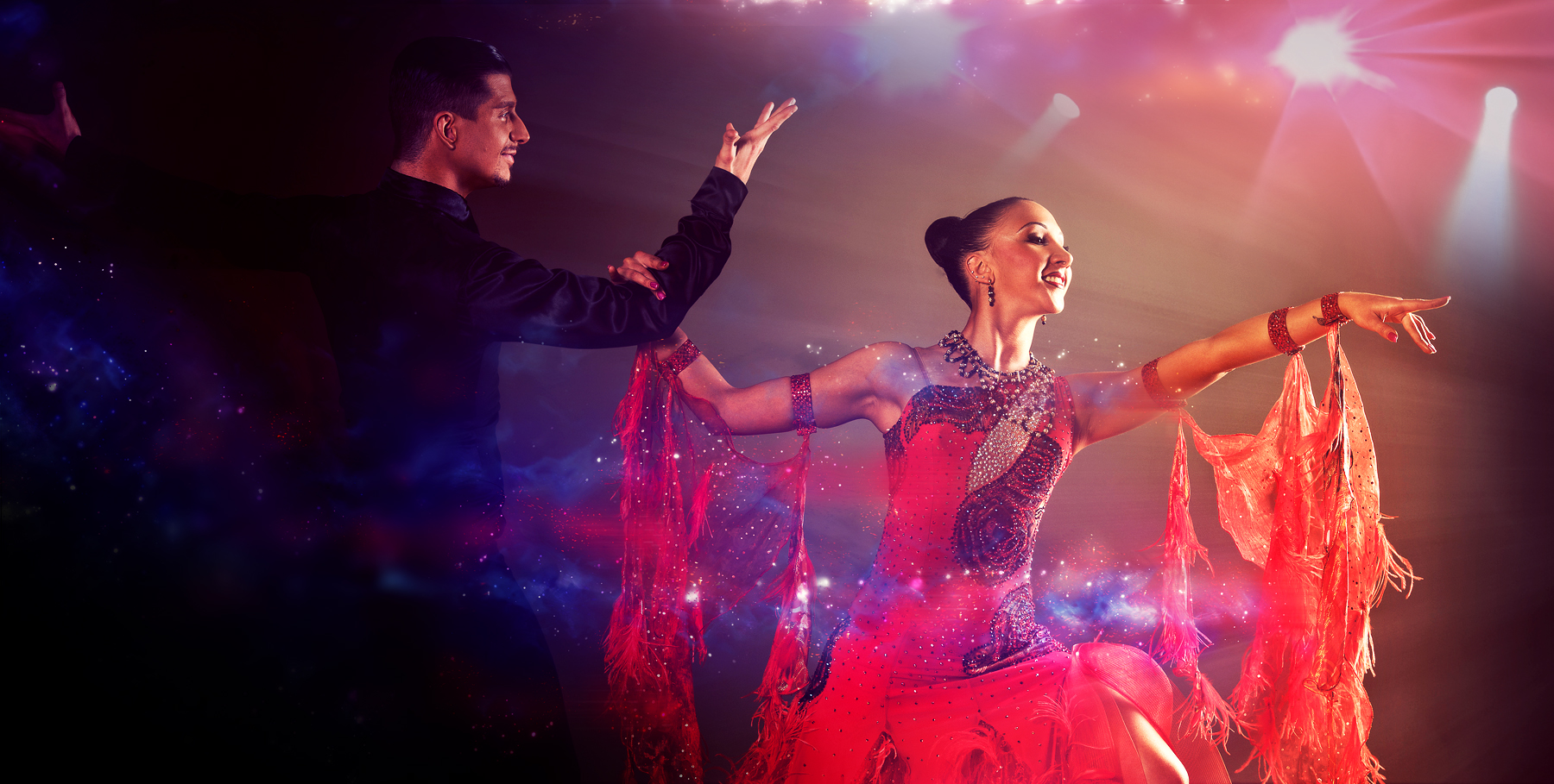 Professional dancers performing in a vibrant, colorful stage show